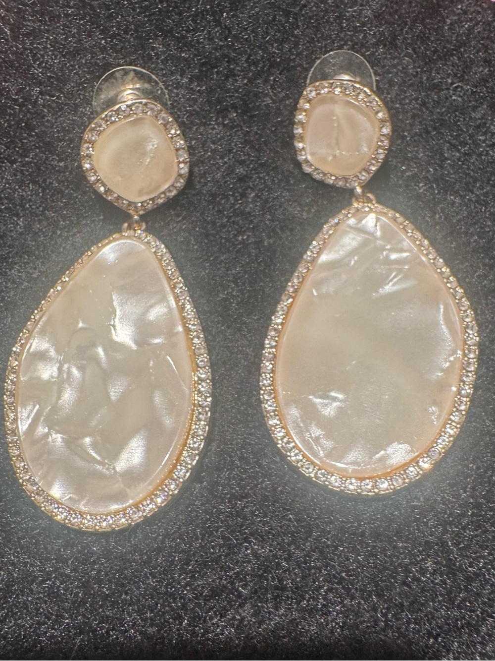 Costume mother of pearl earrings with sparkles. Solid costume piece.